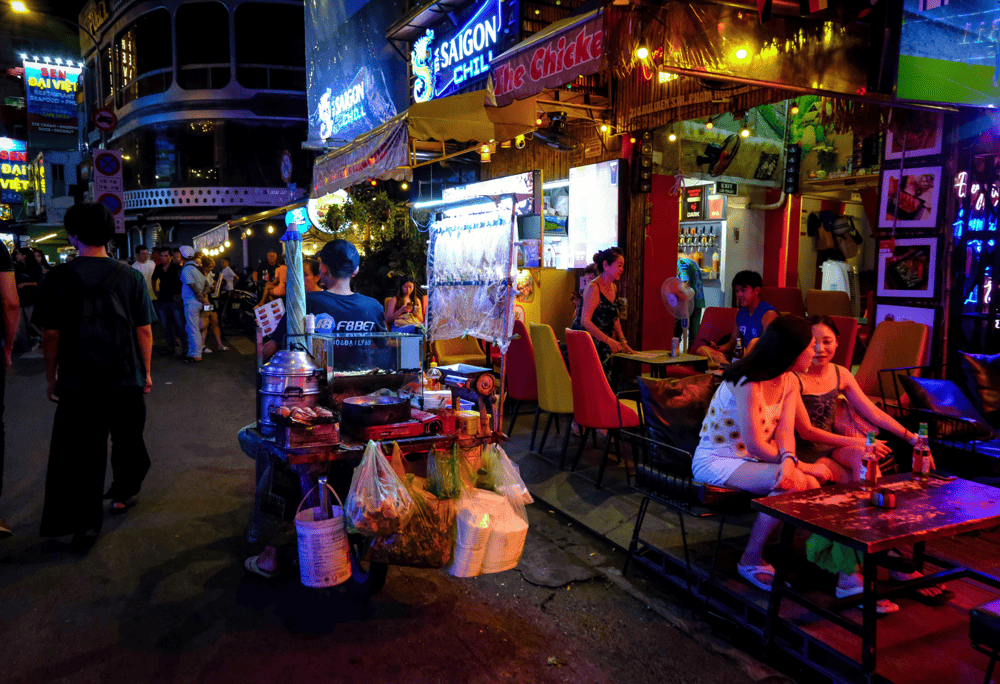 Experience the energy of Saigon’s entertainment hub with its neon lights, bustling bars, and vibrant crowds (Source: Canva)